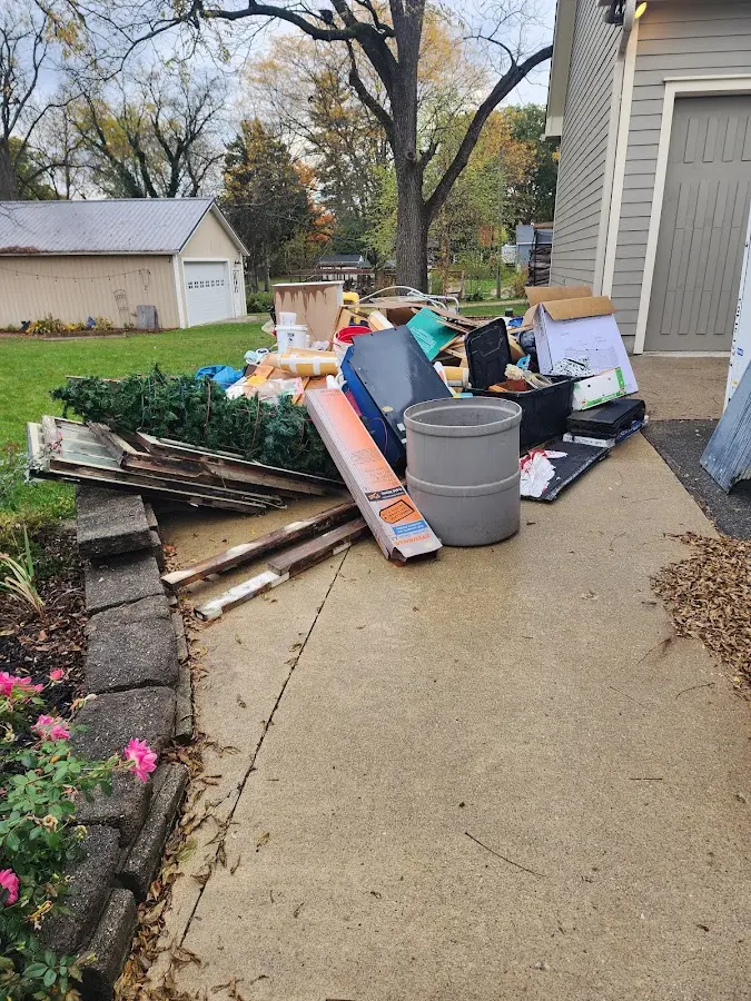 Dumpster being loaded with debris for Commercial Dumpster Rental in Amherst